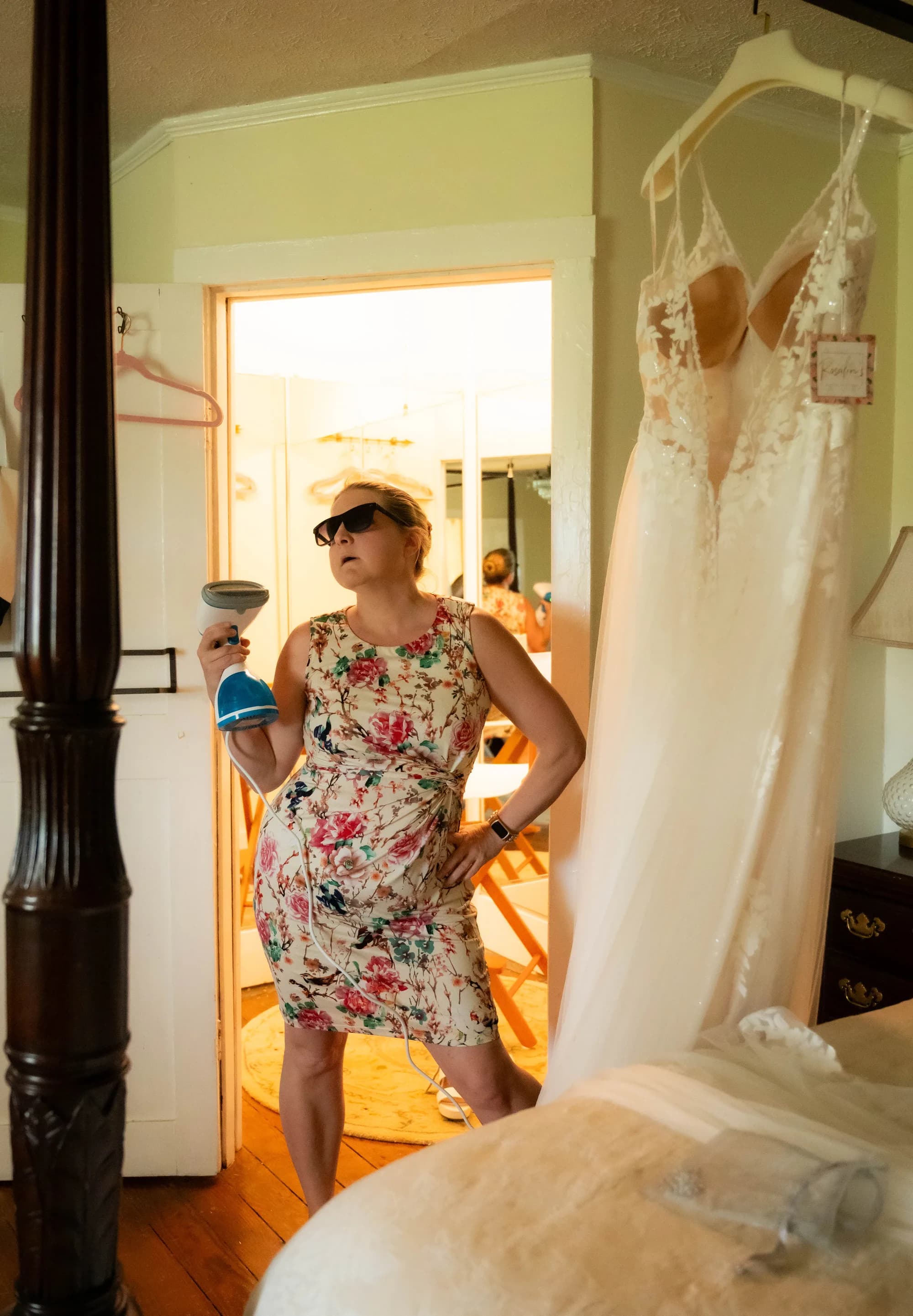 Steaming a wedding dress, sunglasses on